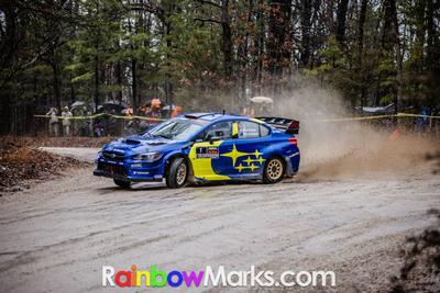 Travis Pastrana and Rhianon Gelsomino in their Subaru at the Rally in the 100 Acre Wood