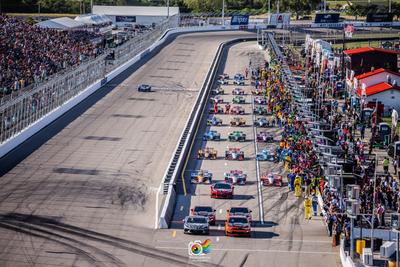 The Front Straight at World Wide Technology Raceway with IndyCars coming out of the pits