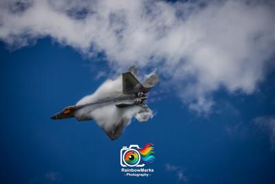 F-22 Demo team in the Raptor with clouds forming on top of the aircraft